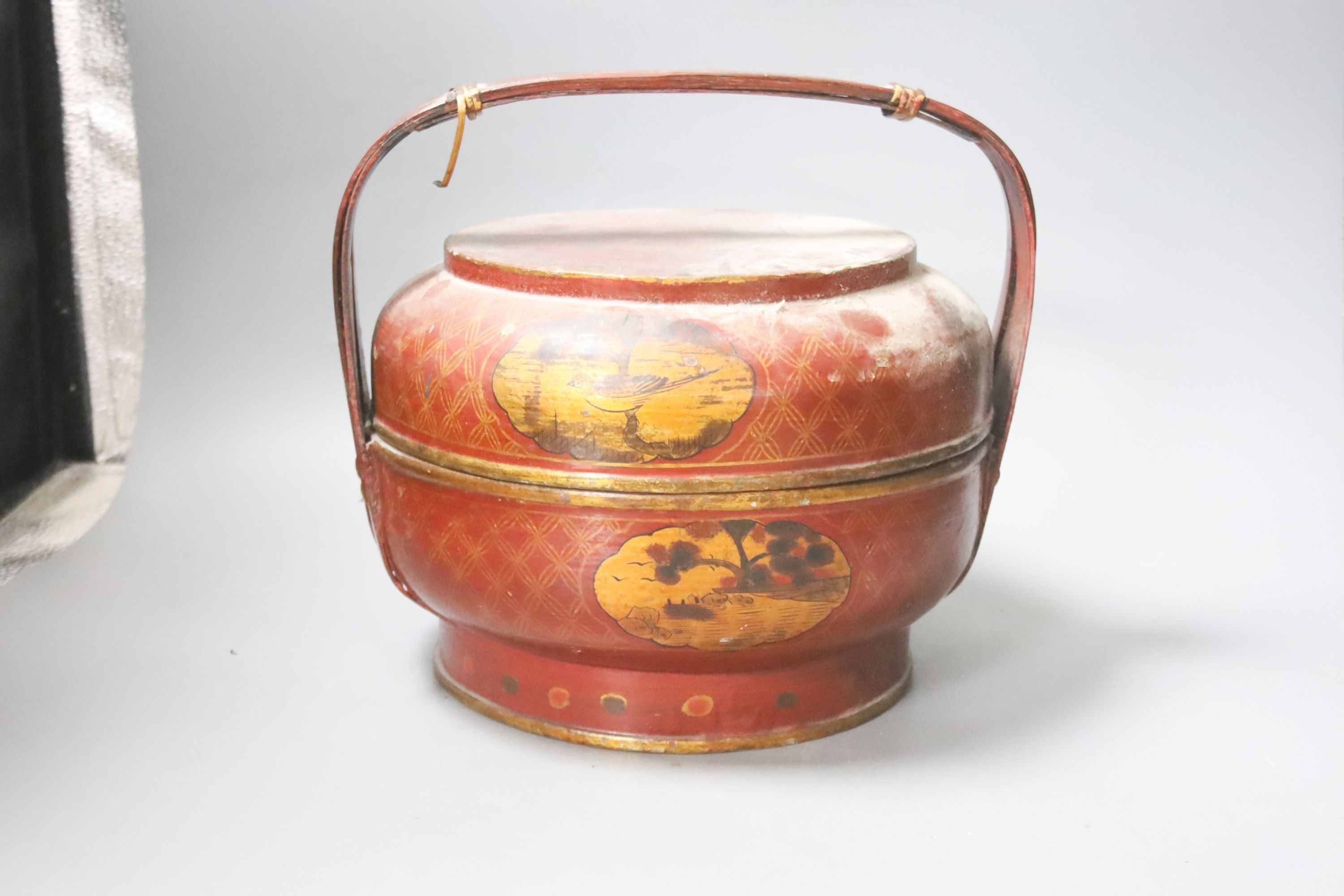 A Chinese large cylindrical porcelain teapot, with bamboo handle and polychrome-decorated with flowers and birds, H 24cm, together with two Japanese red-lacquered containers